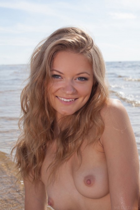 Maria Pie Smiling blonde  in a white t-shirt on the shore