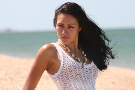 Sarah Beeharee Black-haired  in a white dress on the beach