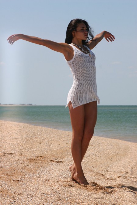 Sarah Beeharee Black-haired  in a white dress on the beach